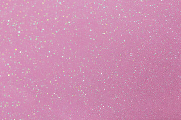 Beautiful glitters shiny texture pink color paper with sparkles, close-up. Glamour background