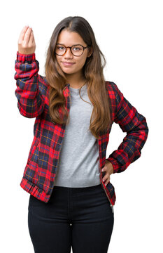 Young beautiful brunette woman wearing jacket and glasses over isolated background Doing Italian gesture with hand and fingers confident expression