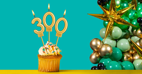 Birthday candle number 300 - Cupcake with decoration on a green background