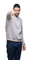 Young handsome man wearing sweatshirt over isolated background looking unhappy and angry showing rejection and negative with thumbs down gesture. Bad expression.