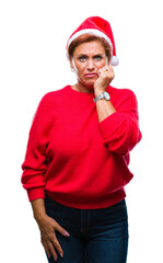 Atrractive senior caucasian redhead woman wearing christmas hat over isolated background looking stressed and nervous with hands on mouth biting nails. Anxiety problem.