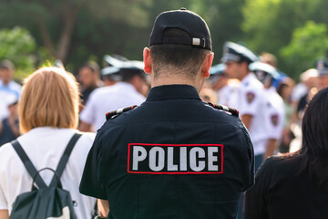 During demonstrations, a policeman with his back to the crowd