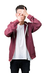 Fototapeta premium Young handsome man over isolated background Covering eyes and mouth with hands, surprised and shocked. Hiding emotion