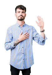 Young handsome business man over isolated background Swearing with hand on chest and open palm,...