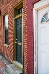 Entrance door to an ancient brick building. Entrance from the sidewalk to the apartment.