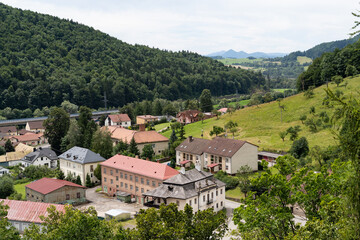 Obraz premium Panoramic view of a small town among the mountains in summer