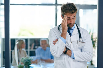 Hospital, doctor and man with headache, stress and worry for medical career, job and work with...