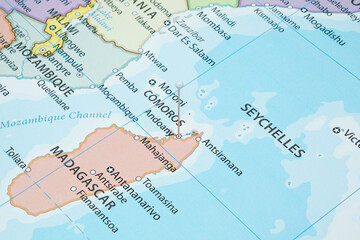 Close up to a Hell Ville city with a white pin needle into Madagascar country political map 