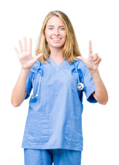 Beautiful young doctor woman wearing medical uniform over isolated background showing and pointing...