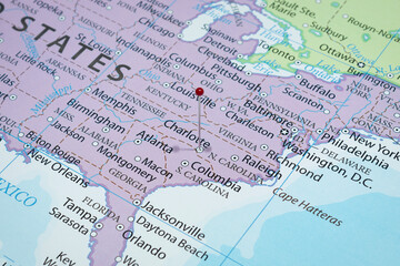 Close up to a Charlotte city with a red pin needle into United States of America country political map 