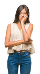 Fototapeta premium Young asian woman over isolated background thinking looking tired and bored with depression problems with crossed arms.