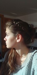 Fototapeta premium Portrait of a young woman with sunlight on her face