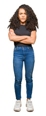 Young beautiful woman with curly hair skeptic and nervous, disapproving expression on face with...