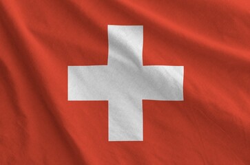Switzerland flag depicted on folded wavy fabric of old cloth close up