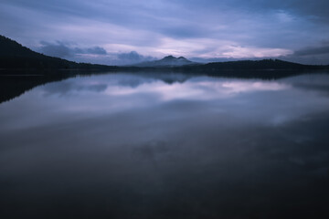 Epic sunrise with reflections on the lake in north Bohemia.  Breathtaking moment when the morning fog looks so mystical.