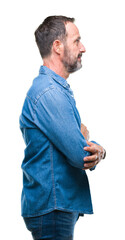 Middle age hoary senior man over isolated background looking to side, relax profile pose with natural face with confident smile.