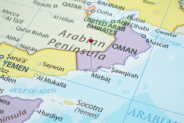 Close up to a Mirbat city with a red pin needle into Oman country political map 