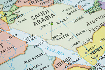 Close up to a Mecca city with a green pin needle into Saudi Arabia country political map 