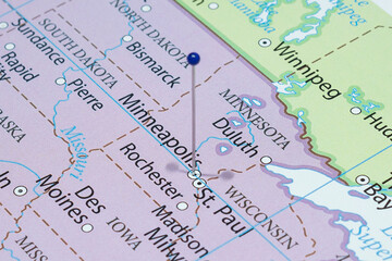 Close up to a Minneapolis city with a blue pin needle into United States of America country political map 