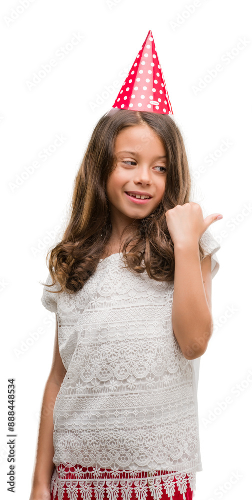 Canvas Prints brunette hispanic girl wearing birthday hat pointing and showing with thumb up to the side with happ