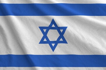 Israel flag depicted on folded wavy fabric of old cloth close up
