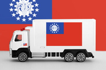 Myanmar flag depicted on side wall of white delivery van close up. Shipping and local delivery concept