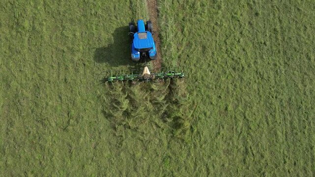 Broadsands, Torbay, South Devon, England: DRONE VIEWS: A farm tractor cuts and levels the grass in a ploughed field. South Devon is an area renowned for arable and livestock farming (Clip 4).