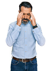 Middle aged man with beard wearing business shirt with hand on head, headache because stress. suffering migraine.