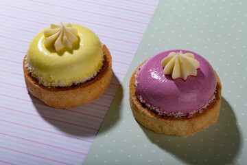 Cute sweet delicious cupcake on desk on pastel background