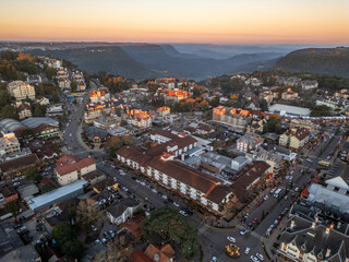 Aerial view of Gramado city buildings with Canyon in background