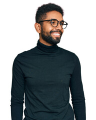 Young african american man wearing casual clothes looking away to side with smile on face, natural expression. laughing confident.