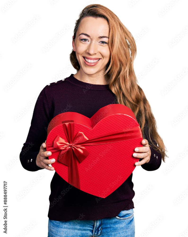 Canvas Prints young caucasian woman holding valentine gift smiling with a happy and cool smile on face. showing te