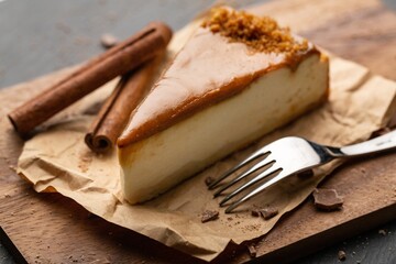 Caramel cheesecake with nuts and cinnamon on kitchen desk