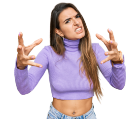 Young hispanic woman wearing casual clothes shouting frustrated with rage, hands trying to strangle, yelling mad
