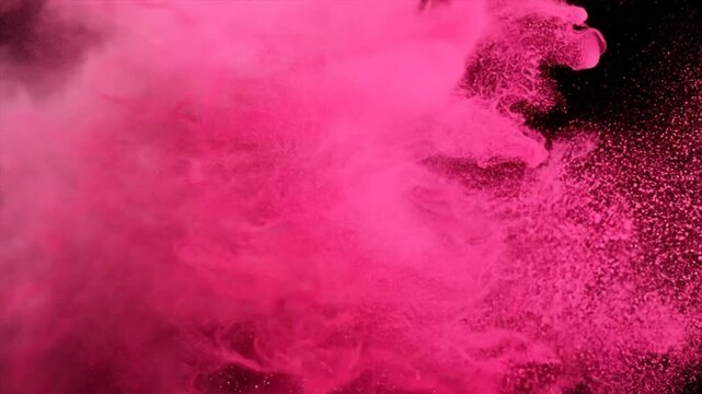 pink color powder splashing over black backdrop
