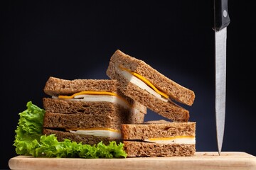 Fresh tasty sandwiches with vegetable on wooden chopping board