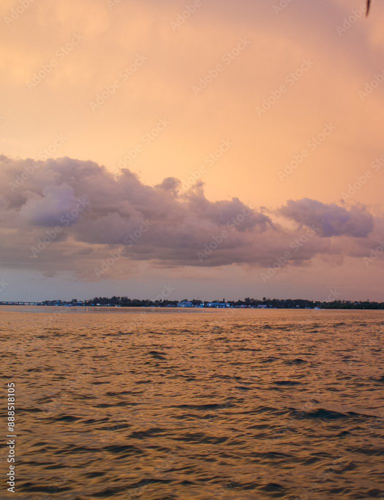 Wall mural sun setting over the gulf of mexico from the point of view of a viewer on a boat.