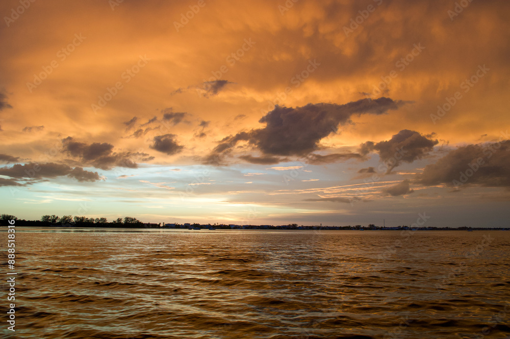 Wall mural sun setting over the gulf of mexico from the point of view of a viewer on a boat.