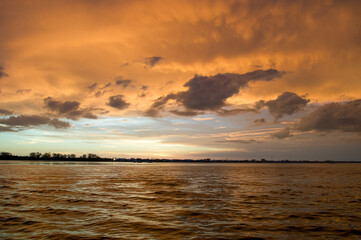 Sun setting over the Gulf of Mexico from the point of view of a viewer on a boat. 