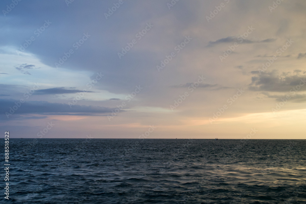 Wall mural sun setting over the gulf of mexico from the point of view of a viewer on a boat.