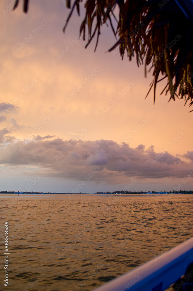 Wall mural sun setting over the gulf of mexico from the point of view of a viewer on a boat.