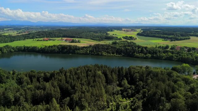Steinsee bei Munchen Luftaufnahme. Steinsee, See in Bayern Luftbildansicht. Lake Stein aerial view near Munich, Bavaria, Germany. One of warmest lakes in Germany. Steinsee is located in forest area. 