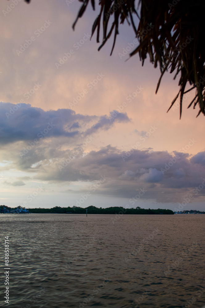 Wall mural sun setting over the gulf of mexico from the point of view of a viewer on a boat.