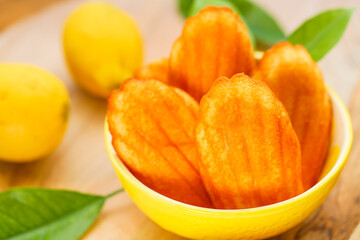 French dessert .Lemon French cookies and lemons fruits in bright sunlight close-up.French madeleine cookies 