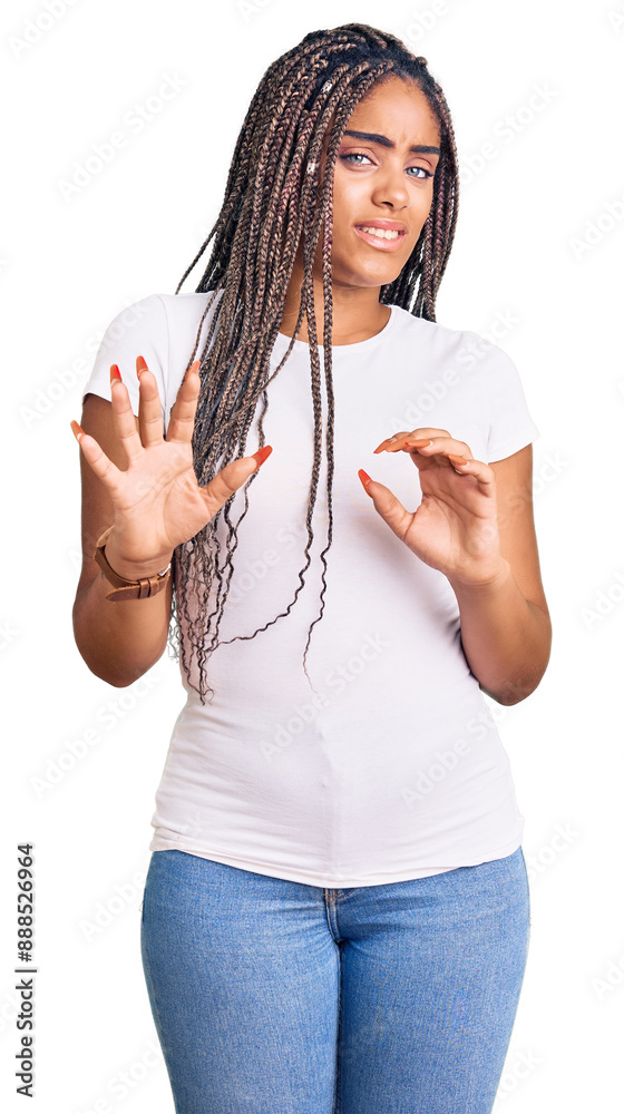 Poster Young african american woman with braids wearing casual clothes disgusted expression, displeased and fearful doing disgust face because aversion reaction. with hands raised