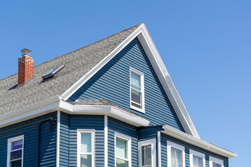 Blue Sided Gable Roofed House Against Clear Sky in Boston, Massachusetts, USA
