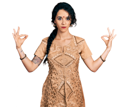 Young indian woman doing gyan mudra relaxed with serious expression on face. simple and natural looking at the camera.