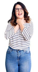 Fototapeta premium Beautiful young brunette woman wearing casual clothes and glasses shouting and suffocate because painful strangle. health problem. asphyxiate and suicide concept.