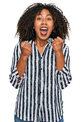 Young african american girl wearing casual clothes celebrating surprised and amazed for success with arms raised and open eyes. winner concept.