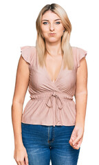 Fototapeta premium Young caucasian woman wearing casual clothes puffing cheeks with funny face. mouth inflated with air, crazy expression.